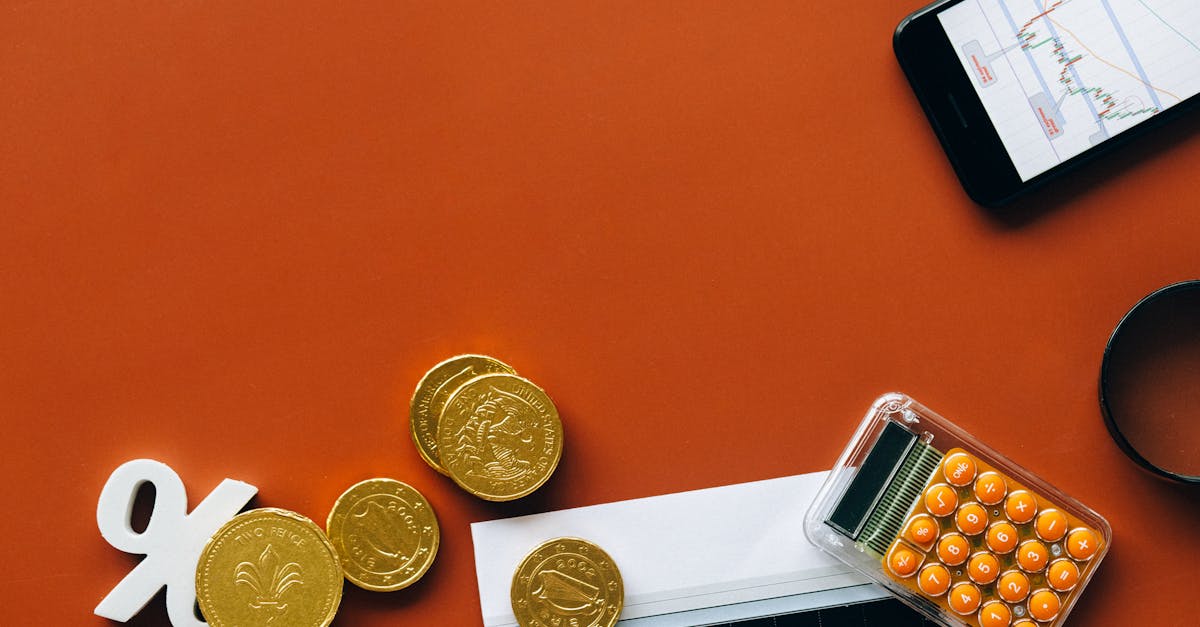 Gold bars next to a stock market chart showing a downward trend with a magnifying glass over interest rate data
